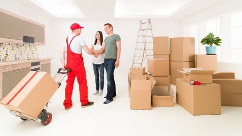 Movers carrying furniture through a Ratcliff apartment building